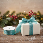 Aqua Merry Christmas ribbon Satin Ribbon<br><div class="desc">Elevate your holiday wrapping with this elegant aqua "Merry Christmas" ribbon. The graceful script adds a touch of sophistication,  perfectly complementing any gift. Its subtle colour palette brings a modern twist to traditional festive decor. Ideal for adding a unique flair to presents or crafts.</div>