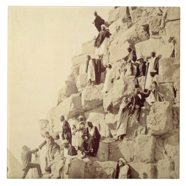 Arabs assisting tourists to climb the pyramids at tile (Front)