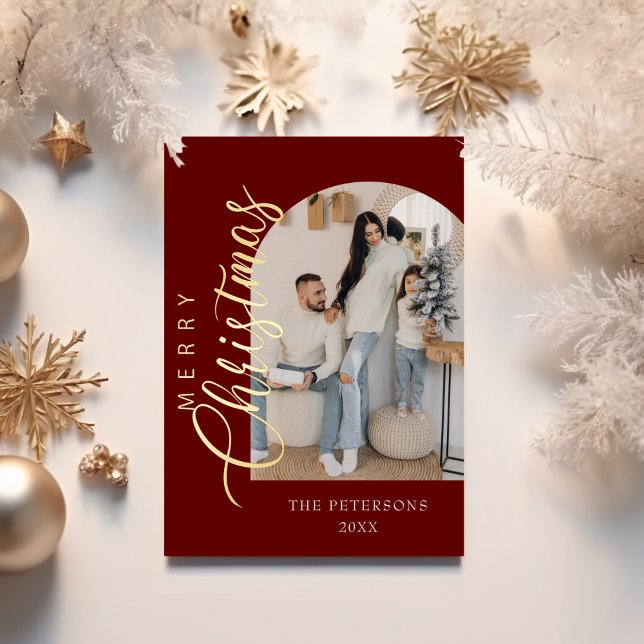 Arch Shape Burgundy Photo Christmas Greeting (Arch Shape Burgundy Photo Christmas Greeting Foil Holiday Card on a table with golden decor.)