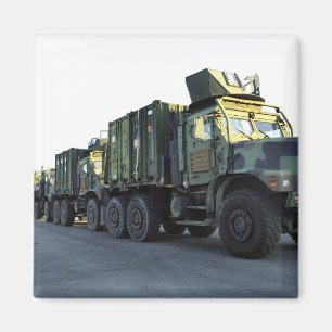 Armoured trucks sit on the pier at Morehead City Magnet