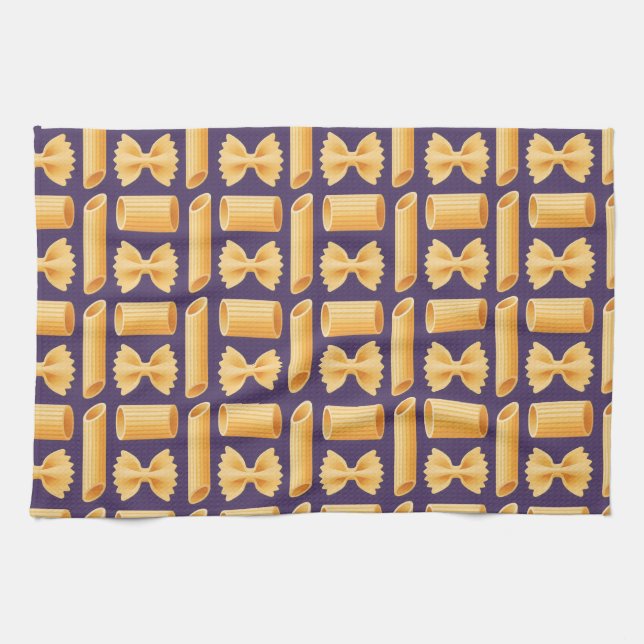 Array of various pasta shapes on a purple tea towel (Horizontal)