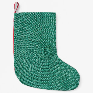 Artificial braided green fabric texture. small christmas stocking