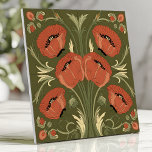 Arts and Crafts Poppy Floral on Olive Green Tile<br><div class="desc">Celebrate timeless design with this Arts and Crafts-inspired tile featuring bold poppy flowers in warm red-orange hues against an olive green background. The symmetrical floral arrangement and intricate leafy details evoke classic vintage charm,  perfect for backsplashes,  accent walls,  or creating a statement piece in any interior space.</div>