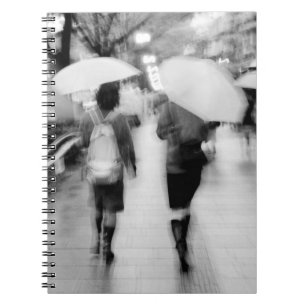 Asia, Japan, Tokyo. Young women and umbrellas. Notebook