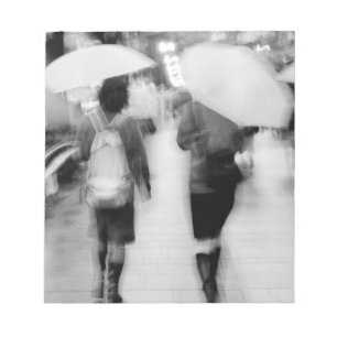 Asia, Japan, Tokyo. Young women and umbrellas. Notepad