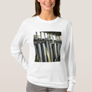 Assault rifles stand ready on the weapons rack T-Shirt