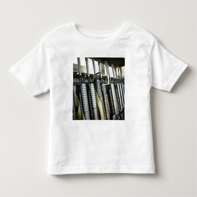 Assault rifles stand ready on the weapons rack toddler T-Shirt (Front)