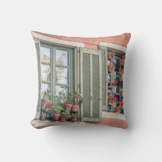ASSORTED-COLOR FLOWERS IN VASE NEAR WINDOW CUSHION
