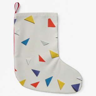 Assorted-colour paper pieces on white surface small christmas stocking