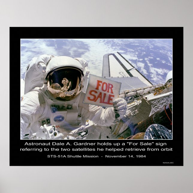 Astronaut Dale A. Gardner holds up "For Sale" sign (Front)