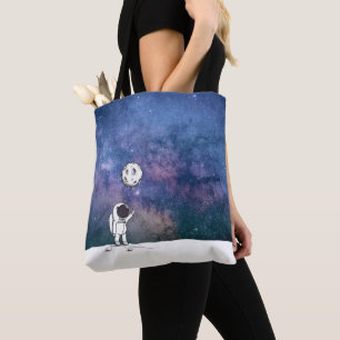 Astronaut in space with moon balloon cosmos stars tote bag