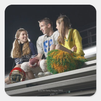 Athletes on bleachers square sticker