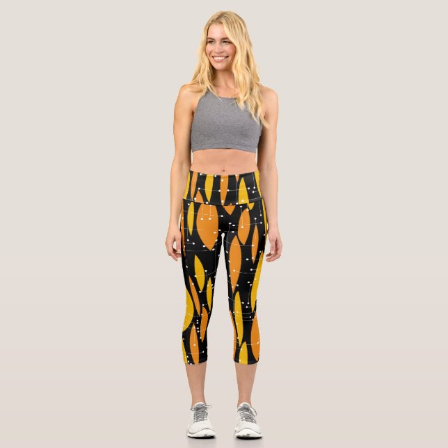 Atomic style, black orange geometric pattern. capri leggings (Front)