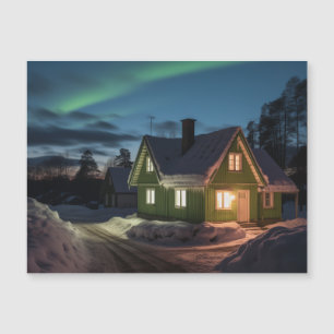 Aurora borealis over winter cabin