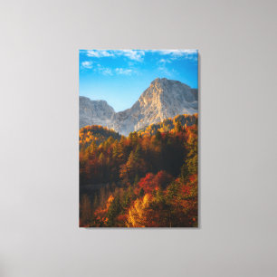 Autumn forest below mountains canvas print