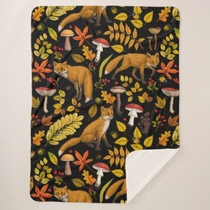 Autumn foxes on black sherpa blanket