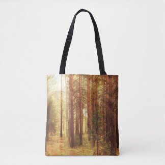 autumn landscape background, sun rays in the fores tote bag