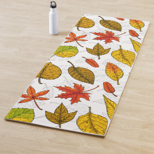 Autumn leaves on white yoga mat
