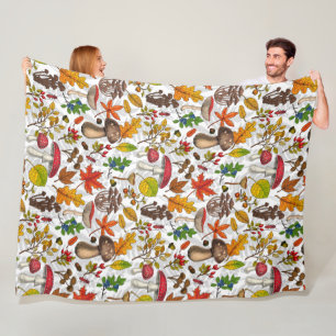 Autumn mushrooms, leaves, nuts and berries on blue fleece blanket
