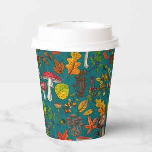 Autumn mushrooms, leaves, nuts and berries on blue paper cups