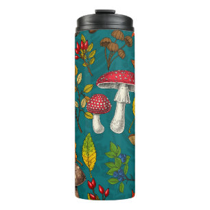 Autumn mushrooms, leaves, nuts and berries on blue thermal tumbler