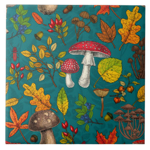 Autumn mushrooms, leaves, nuts and berries on blue tile