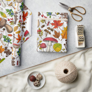 Autumn mushrooms, leaves, nuts and berries on blue wrapping paper