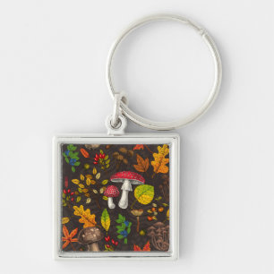 Autumn mushrooms, leaves, nuts and berries on dark key ring
