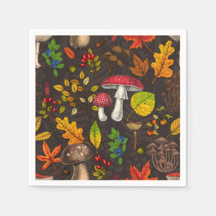 Autumn mushrooms, leaves, nuts and berries on dark napkin