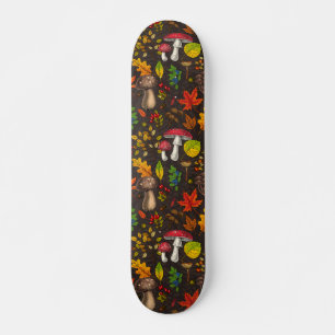 Autumn mushrooms, leaves, nuts and berries on dark skateboard