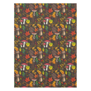 Autumn mushrooms, leaves, nuts and berries on dark tablecloth