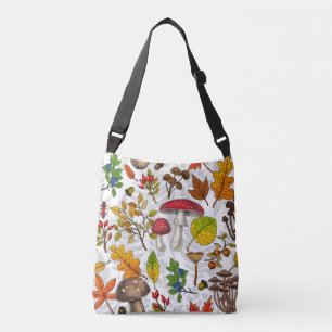 Autumn mushrooms, leaves, nuts and berries on whit crossbody bag