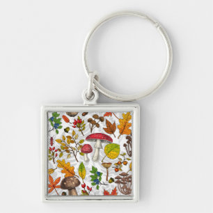 Autumn mushrooms, leaves, nuts and berries on whit key ring