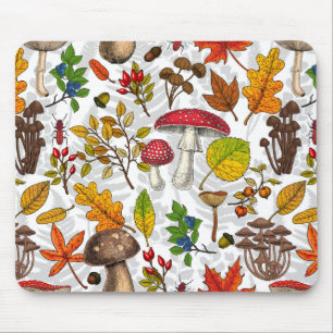 Autumn mushrooms, leaves, nuts and berries on whit mouse pad