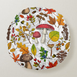 Autumn mushrooms, leaves, nuts and berries on whit round cushion