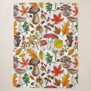 Autumn mushrooms, leaves, nuts and berries on whit sherpa blanket