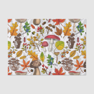 Autumn mushrooms, leaves, nuts and berries on whit tissue paper