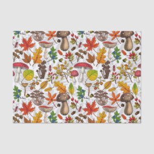 Autumn mushrooms, leaves, nuts and berries on whit tissue paper