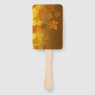 Autumn pattern with falling maple leaves and bokeh hand fan