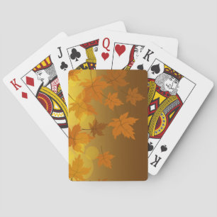 Autumn pattern with falling maple leaves and bokeh playing cards