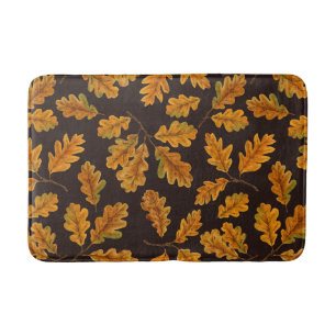 Autumnal oak leaves on dark brown bath mat