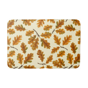 Autumnal oak leaves on off white bath mat