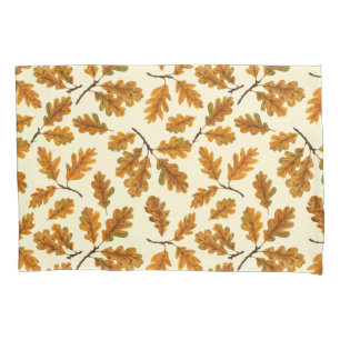 Autumnal oak leaves on off white pillowcase