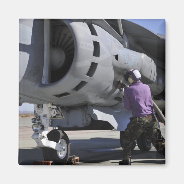 Aviation fuel technician attaches a fuel line magnet (Front)