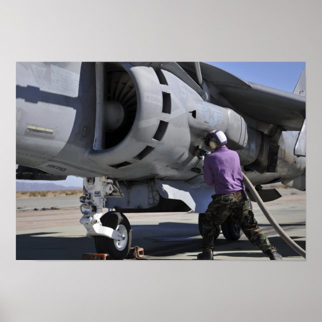 Aviation fuel technician attaches a fuel line poster (Front)