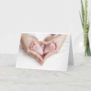 Baby feet in mother hands card