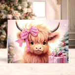 Baby Highland Cow With Pink Bow Christmas Holiday Card<br><div class="desc">Spread festive joy with our Baby Highland Cow With Pink Bow Christmas Holiday Card! This delightful card features a charming illustration of a cute baby highland cow adorned with a big pink bow, surrounded by holiday decorations and presents. Perfect for sharing heartfelt wishes with friends and family, this card captures...</div>