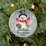 Baby's First Christmas cute snowman black hat  Ceramic Tree Decoration<br><div class="desc">A whimsical Christmas tree ornament featuring an adorable snowman surrounded by delicate snowflakes. Customise it with your child's name and the year for a personalised touch that captures the joy of the season.
Use the "Personalise" button to customise to your liking.</div>