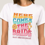 Bachelorette Party Groovy Retro Wavy Text Bride T-Shirt<br><div class="desc">Make a splash at your upcoming bachelorette party with this stunning bachelorette party personalised t-shirts. Whether you're celebrating a bach trip, a girls' vacation, or a best friends' holiday, this custom beach bachelorette party t-shirts are the perfect addition to your unforgettable getaway. Add a personal touch to your bachelorette party...</div>