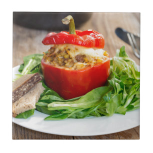 Baked stuffed peppers with meat sauce and cheese tile